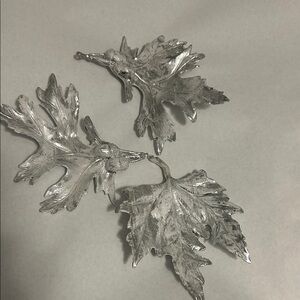 Set of 3 silver & white frosted decorative holiday leaves.